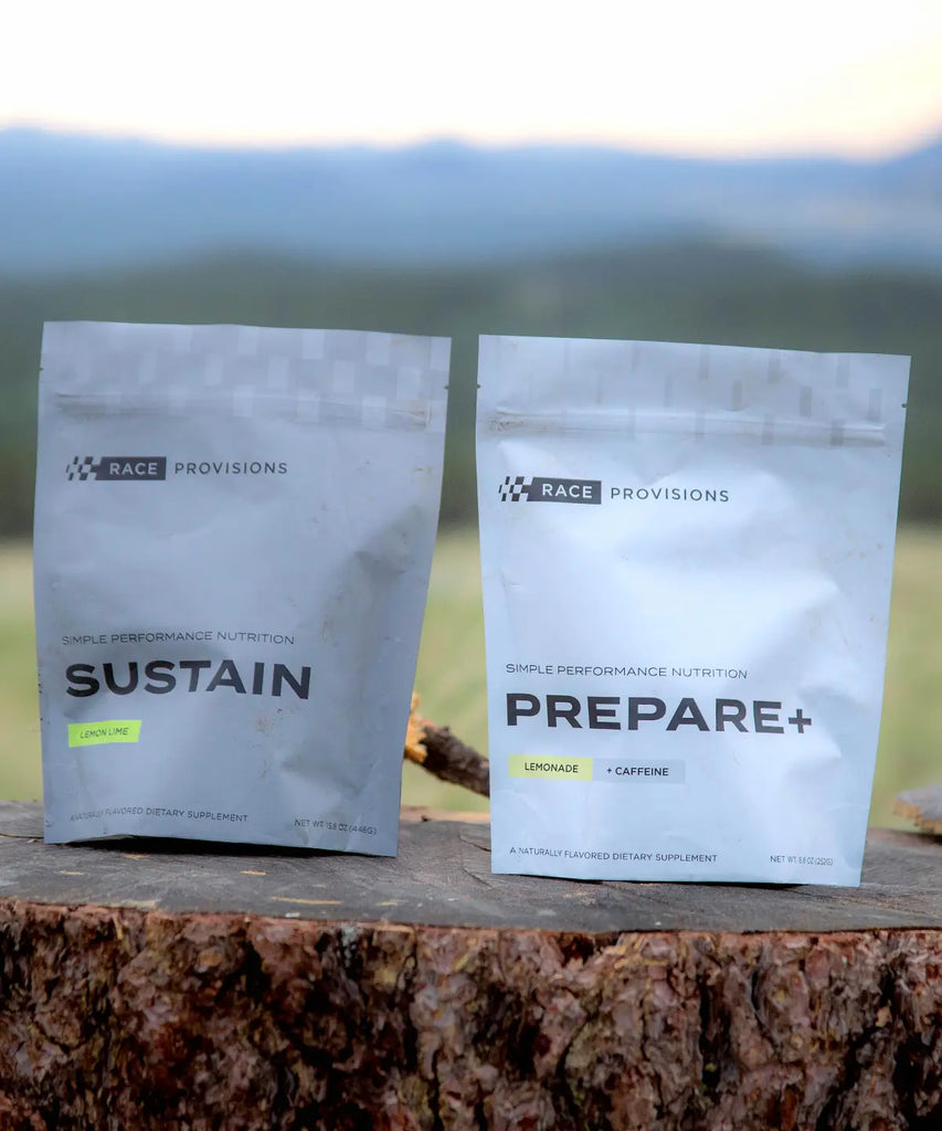 PREPARE+ Pre-Ride Performance Supplement Drink Mix -- Paired with SUSTAIN Intra-Ride drink mix, shot outside sitting on a log. Both products are made for dirt bike or mountain bike riders.